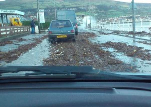 The debris-strewn Antrim Coast Road at Carnlough which had been closed for a time today (Friday). Picture from Twitter by 'Wee Round Ian' @wee_baldy_ian