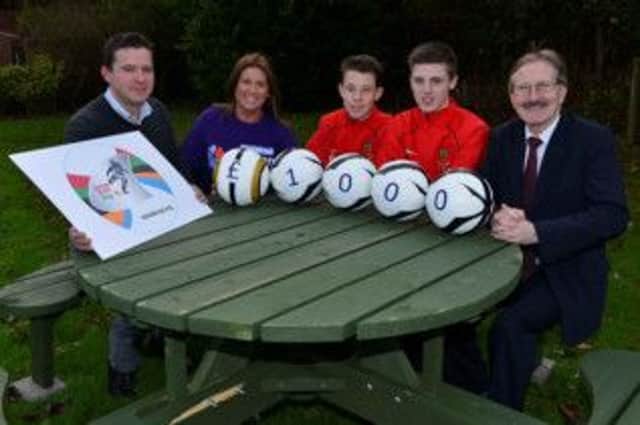 Northern Ireland Cup Chairman Victor Leonard (right) along with County Antrim Chairman Lawrence Anderson (left) and County players Kyle McClean and Josh Curry, hand over a cheque to Noreen Kennedy, Northern Ireland Childrens Hospice.