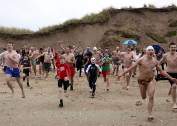 Race to the water! New Years Day swimmers at Magilligan for the fund raising event in aid of the Foyle Hospice. INLV0113-026KDR