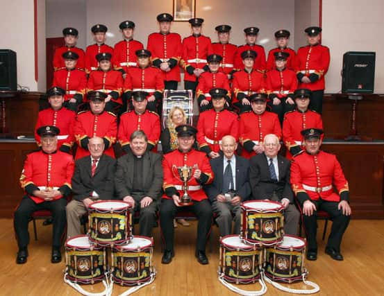 Members of the Churchill Flute Band, pictured at the dedication and presentation of a band cup in memory of band member Drew Porter, held in the Apprentice Boys Memorial Hall, Londonderry.  Included seated (second from left) are Derek Nutt, band chairman, the Dean of Derry Very Rev. William Morton, Simon Mowbray, bandmaster, Walter McLaughlin, president and James Thompson, vice-chairman.  INLS 1214-515MT.