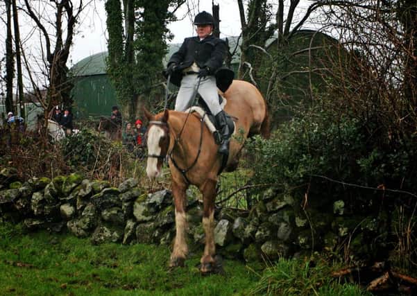 Colin Thompson clears a jump during the Mid-Antrim New Years Day hunt. INBT02-209AC