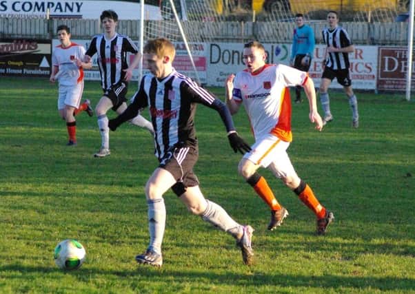 Carrick skipper Aaron Harmon gives chase in Saturday's 2-1 defeat to Dergview. Photo: Adam Simpson