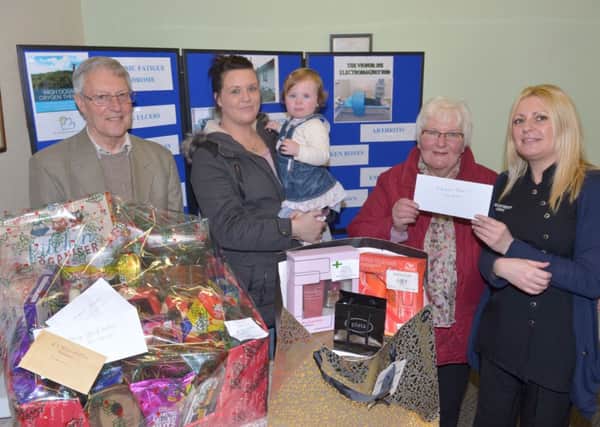 Vickie Shaw (right) presents winners of the Oxygen Therapy Centre ballot with their prizes. Peter Illingworth won the Christmas hamper, Lacey McClean and her mum Lesley-Ann won the pamper hamper and Pat Bell won East Antrim Electrical vouchers. There were a total of 13 prizewinners. INLT 02-354-PR