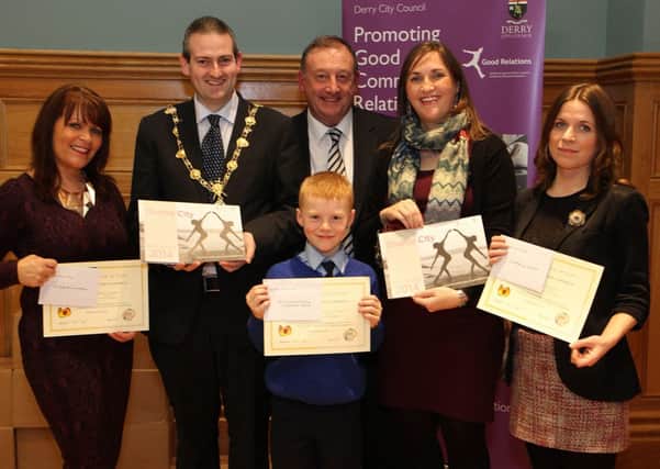 The Mayor of Derry Councillor Martin Reilly, with Angela Askin (second from right), Derry City Council community relations officer,  present certificates to winners in the Adult - Faces in Local Places category of Derry City Councils  Spice of Life, Diverse City Calendar photographic competition, at the launch of the calendar, held in the Guildhall.  From left are Catherine Pollock (2nd place), Paul OHea , principal of Nazareth House PS, with Liam McDaid, who took 1st place and Margaret Cunningham (3rd place).