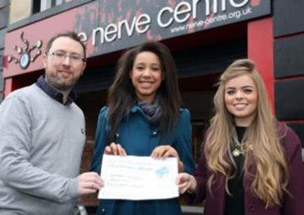 Gemma Bradley, winner of the Best Youth/Under 18 Act in Resonate Music project run by the Nerve Centre as part of the 2013 UK City of Culture celebrations, receives her prize of music vouchers from Ruairi OKane, the National Lottery and Natasha Deeney, the Nerve Centre.