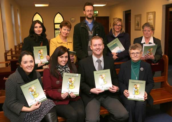 Scott Otley (seated second from right) of Browns Houston & Williamson in Whiteabbey with local school and church representatives at the launch of the Amy and Tom book, which is designed for adults helping children who are trying to cope with sudden bereavement.