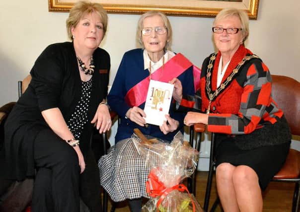 Ballymena Mayor Councillor Audrey Wales on behalf of Audrey Wales, Ballymena Mayor;  presented a 100th birthday card and bouquet of flowers to Slemish Private Nursing Home resident Bridget McKeown. Looking on is Nurse Manager Dorothy McKee. INBT 03-802H