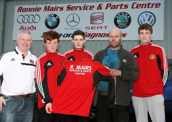 Gary Mairs, of Ronnie Mairs Service and Parts Centre, presents sponsored training tops to Carniny Youth U-16 members Adam Mairs, Jamie Killough and Tyrone Balmer and coach Billy O'Flaherty. INBT03-240AC