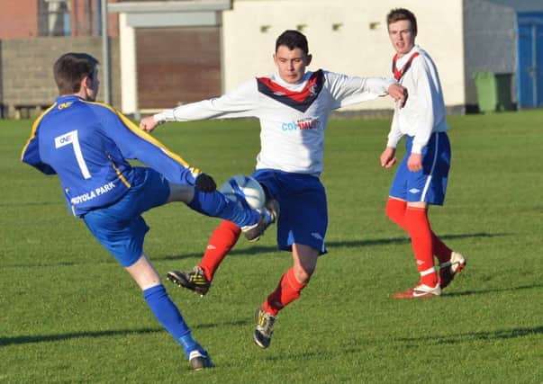 Stevie White in action for FC Larne in their game against Moyola Park Olympic at Sandy Bay.