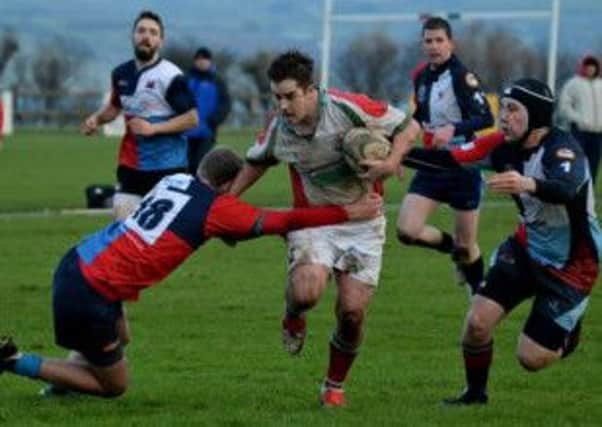 Larne's Cary Aston exploiting a gap in the Quins' defence. Photo: Bill Guiller