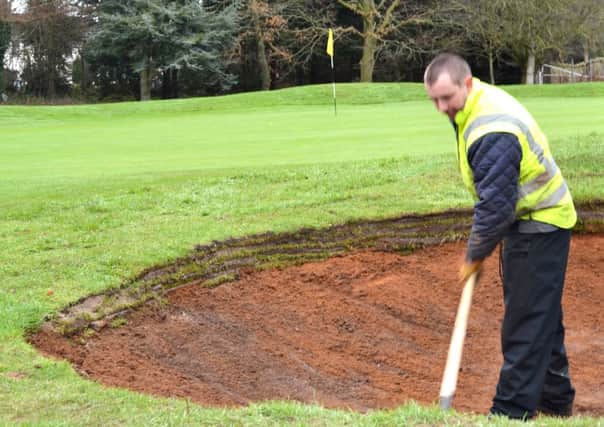 Johnny Burns puts the final touches to the new bunker at the third hole at Lisburn.