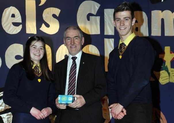 Anne-Marie Mulholland (current Head Girl) and Shea Heffron (current Head Boy) presenting a token of appreciation to Mr Mickey Harte. INLM03-142gc