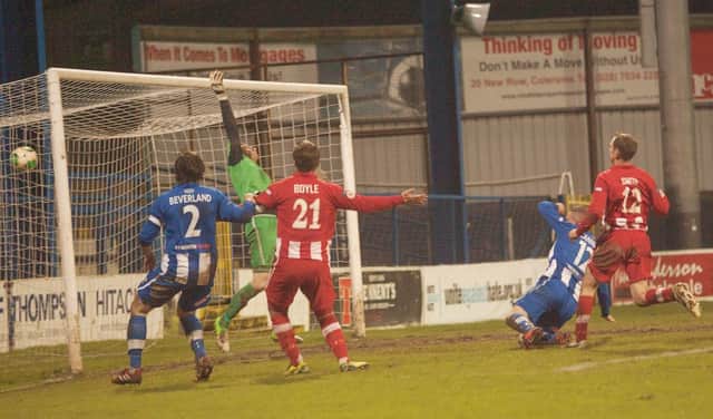 Aaron Canning's header hits the back of the Warrenpoint to put Coleraine in front at The Showgrounds.