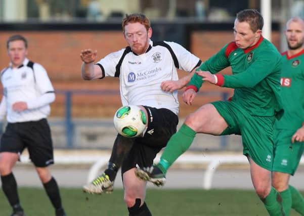 The Fifth Round Irish Cup game between Lisburn Distillery and PSNI at New Grosvenor. Distillery's Ben Browne and PSNI's John Brendan Dobbin battle for the ball. Picture: Cliff Donaldson