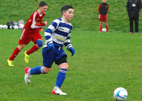 A Northend under-13 player charges forward with the ball during Saturday's NIBFA Cup tie against Carniny at Ballykeel. INBT 04-913H