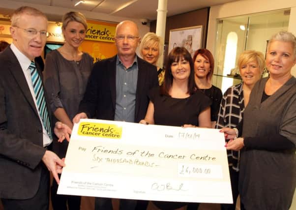 BOND DELIVERY. Colin and Jennifer Bond (3rd left and right), pictured on Friday morning presenting a cheque for the magnificant sum of £6,000.00 to Claire Hogarth, Fundraising Manager for Friends of the Cancer Centre at the City Hospital. Included along with staff is MLA Gregory Campbell.CR4-113SC.