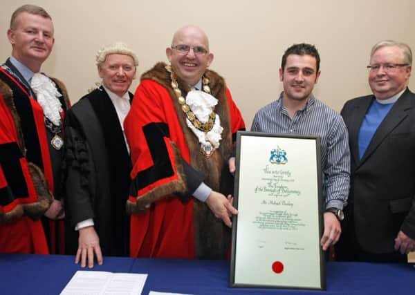 FREEDOM. Mayor Cllr John Finlay presents Michael Dunlop with the Certificate of the Conferment of the Freedom of the Borough on Friday with Deputy Mayor Cllr Ian Stevenson, Chief Executive John Dempsey and Mayor's Chaplain Rev James Simms looking on.INBM4-14 033SC.