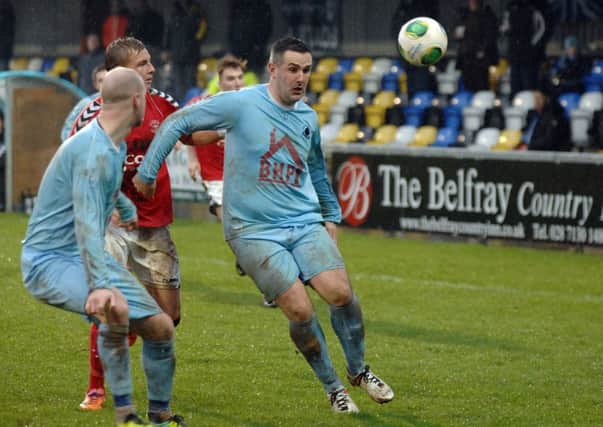 Institute's Stephen Parkhouse and Stephen O'Flynn push into the Larne box during their game on Saturday.