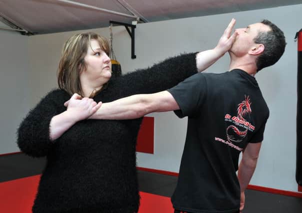 Wendy Martin demonstrates a self defence technique on husband Neil. INLM04-100gc