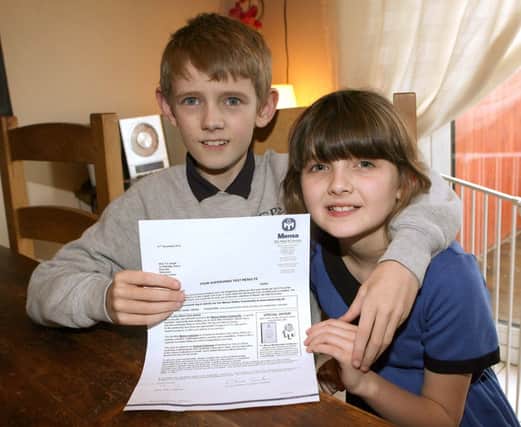 Taylor Smyth (11) shows his sister, Grace (9) the letter inviting him to join the high IQ society, Mensa. INNT 04-006-FP  Pic by Freddie Parkinson