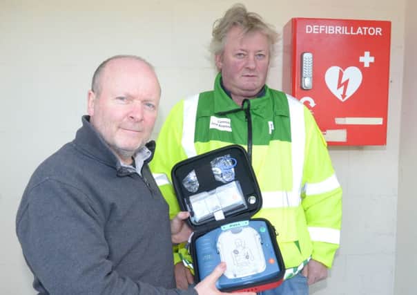 Stephen Caldwell and Gerry Armour with the defibrillator at the Islandmagee Spar. INLT 04-312-PR