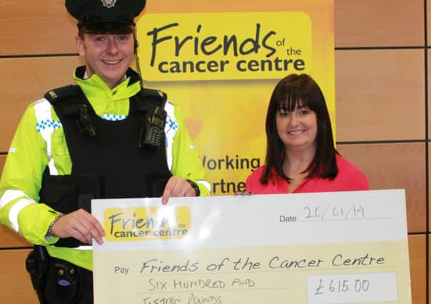 Constable Chris Glasgow handing over a cheque for £615 to Claire Hogarth, Events and Community Fundraising Manager for Friends of the Cancer Centre, after a Ballymena investigation saw the confiscation of cash from an individual convicted of drugs offences.