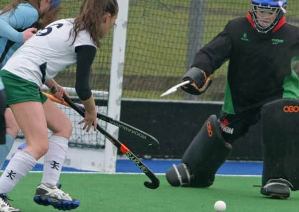 KEEP OUT. Ballymoney 2nds keeper prevents Queens from scoring in this attack during their game on Saturday.INBM4-14 050SC.