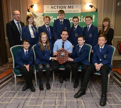 Alan Beattie and pupils from Ballyclare Secondary School are presented with their award at the Action MS Thank You luncheon at the Ramada Hotel in Belfast. Also pictured are Jacqueline Keegan of Action MS and patron of Action MS and well-known DJ, Connor Phillips. INNT 05-451-CON