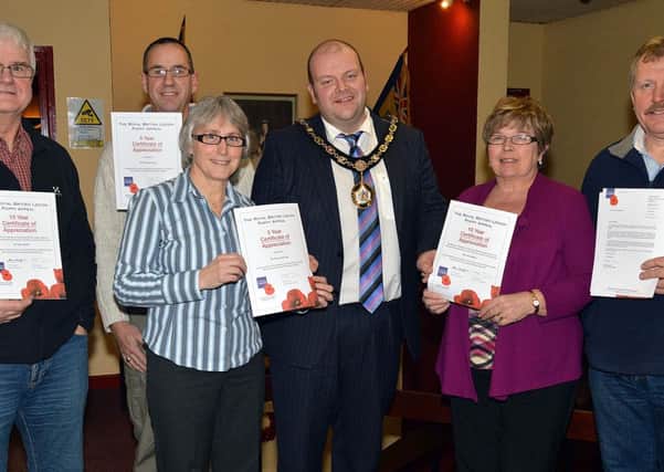 Mayor of Craigavon, Councillor Mark Baxter, presents certificates of appreciation to long serving Poppy Appeal Collectors at a special supper for volunteers. Included are from left, Sam Martin, 10 years service, Willaim Clarke, 5years service, Roberta Mcnally, 5 years service, Betty Derby representing Neta Dillon who was unavailable, 10 years service and George McNally, 5 years service. INLM04-209.