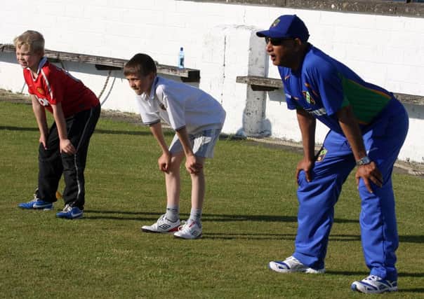 North West Warriors Head Coach Bobby Rao, joins Mathew Cooke and Robbie Millar, during a coaching session at Eglinton Cricket Clubs weekly junior coaching session. INLS1323-514MT
