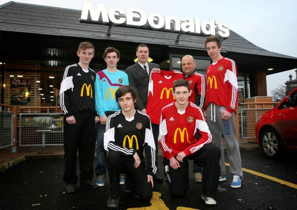 Stephen Armstrong (coach) along with players from Carniny Youth are pictured receiving their new kits from Karl Black (manager) of McDonald's Ballymena. The club's new strips are sponsored by the restaurant as part of the McDonald's Club Twinning programme, designed to create opportunities and build community relationships buy funding football projects that allow clubs to grow. For more information of club twinning and other McDonald's football programmes visit www.McDonalds.co.uk/KickStart. INBT04-223AC