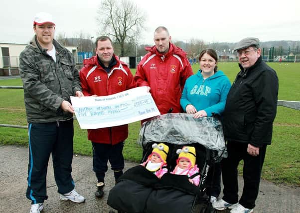 Michael and Caroline Spiers along with Boyd Douglas and girls Chloe and Rebecca pictured with Braid United FC representatives Nathan Selwood (manager) and Ian Young (assistant manager) who presented them with a £500 cheque proceeds of a charity football match between  Braid United and Braid Old Boys. The money is going to the neonatal unit in Antrim Area. INBT 04-928H
