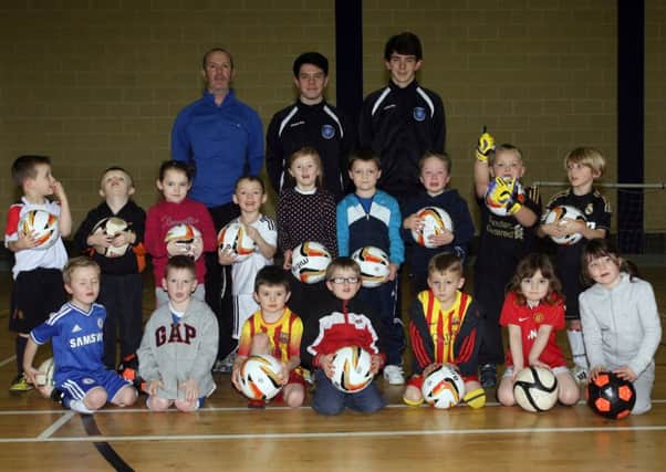 Some of the participants in the North End Youth football development centre pictured along with coaches John Devlin, Matthew King and Jack McKenna. INBT05-214AC
