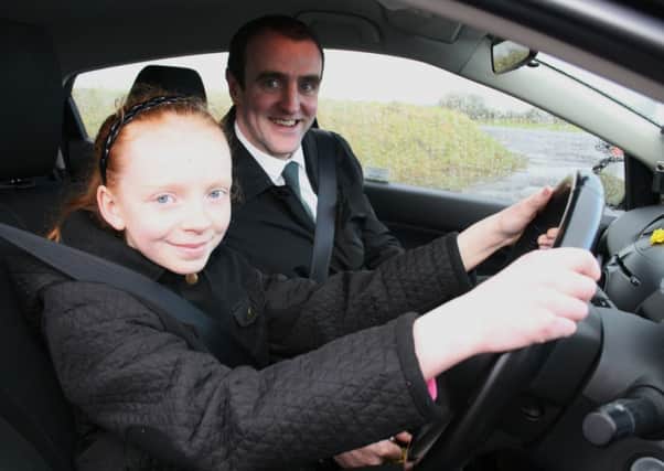 Environment Minister Mark H Durkan pictured with Aisling Conaghan (aged 11) at the Cruise centre, Eglinton.