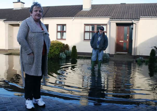 Roisin and Michael outside their homes surrounded by flood water in Churchtown