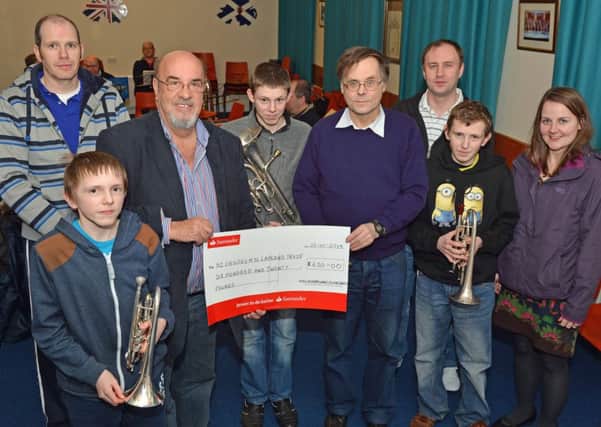 Members of Magheramorne Silver Band present a cheque for £620 to Jack Rodgers MBE,Chairman of the Northern Ireland`s Children to Lapland Trust. INLT 05-003-PSB