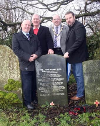 The Mayor of Ballymoney Councillor John Finlay, Alderman Bill Kennedy, Frankie Cunningham and Steven Phillips from Dervock and District Community Association at the grave of Private John Meeke at Derrykeighan Old graveyard.INBM06-05-14 Pic Lyle McMullan