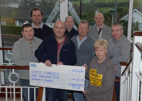 Members of Olderfleet Masonic Lodge 501 hand over a cheque for £1400, raised with a walk from Ballygally to Larne Masonic Centre, to Linda Alexander, Regional Fundraising Manager of Cystic Fibrosis. INLT 05-305-PR