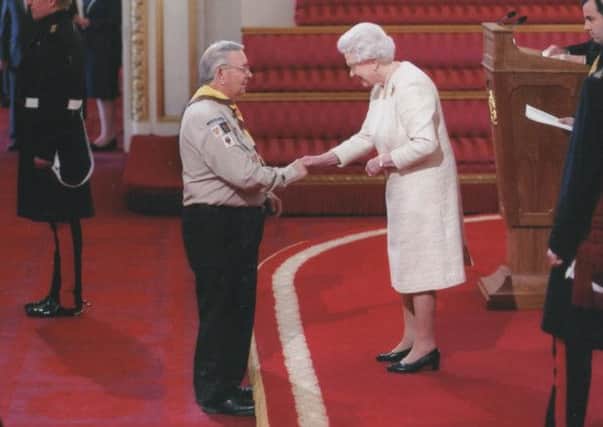A Proud Moment: Andrew Millar is presented with an MBE by HM Queen Elizabeth at Buckingham Palace for services to scouting.