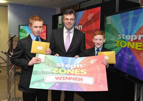 St Louis Grammar, Ballymena has won Invest Northern Ireland's 2013 Step 'N' Zones Competition with a business idea for football boots with studs that can be used on any surface. Pictured are Charlie Henry (left) and James Logan, pupils from St Louis Grammar with Invest NI Chief Executive, Alastair Hamilton. Picture: Michael Cooper
