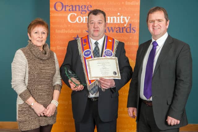 Nigel Bamford, Worshipful Master of Ballymaconnelly True Blues LOL 360 (centre), receives the Lodge Community Involvement Award on behalf of the Rasharkin Lodge. INBM06-14