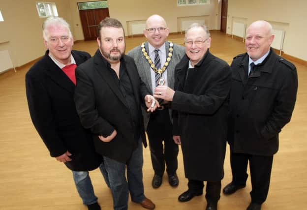 KEY MOMENT. Cllr Frank Campbell hands over the keys of the newly built Community Centre in Dervock to Frankie Cunningham with Cllr Bill Kennedy, Mayor Cllr John Finlay and Steven Phillips looking on.INBM6-14 002SC.