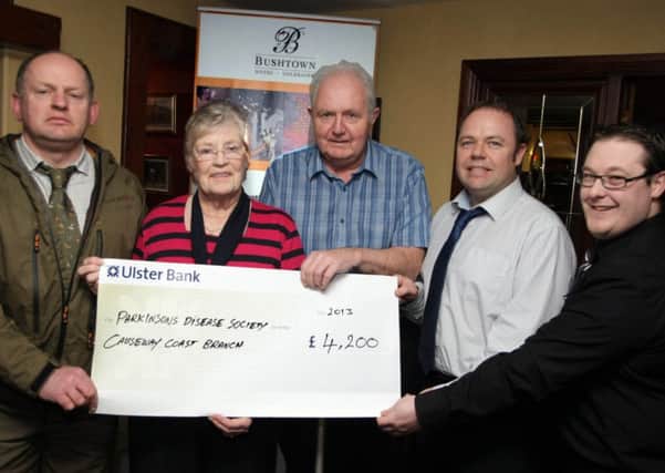 GAME ON. Kieran McGilligan, Proprietor of the Bushtown Hotel and Supervisor Terrance O'Hagan (2nd right and right respectively), pictured handing over a cheque for £4,200.00 to Ethna Watterson MBE and Trevor Wilson from the Causeway Branch of Parkinson's UK. The money was raised at Game Nights and included (left) is Terrance O'Hagan, Gamekeeper at Fairview.CR5-108SC.
