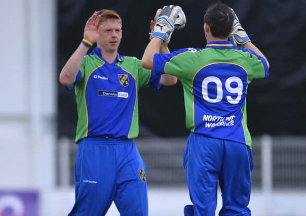 North West Warriors Craig Young celebrates with Ricky Lee Dougherty, after taking a wicket against Leinster Lighting.