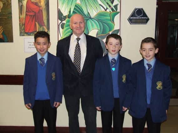 Mr Paul Cunning congratulates Loreto College Year 8 students Caleb Wan (first), Odhran McLarnon (second) and John Butcher (third) on their success in the Mary McCabe Cross Country Race.
