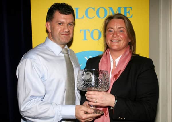 Michael Smyth, of sponsors Wrightbus, presents the Coach of the Year award to Debbie Byrne. INBT06-218AC