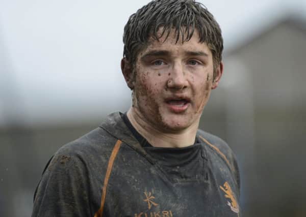 Mud covered Foyle College skipper Patrick Leeson takes a breather during a break in play, against Limavady Grammar in the last round.