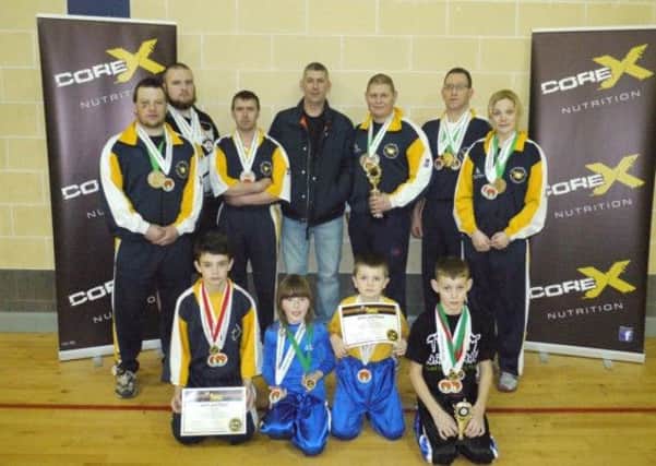 Jan Ling Freestyle Kung Fu & Kickboxing Club who took part in the WKC NI qualifiers. Back row l-r Paddy McLaverty, Brien 'Grizz' Gillen, Mervyn Carson, Dominic Logan (Core X Nutrition the clubs sports supplement sponsor), Darren Donnell, Ernie Johnston & Lisa Millar. Front row l-r Ryan Sharpe, Josie Carson, Jacob Sharpe & Curtis Donnell.