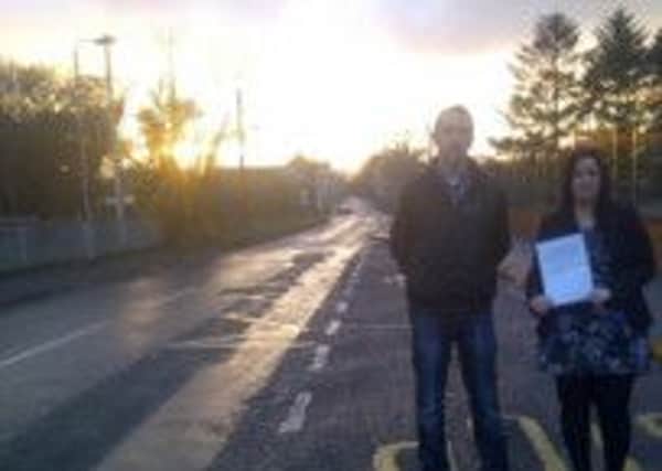 Daithí McKay MLA and Leanne Peacock pictured with the road safety petition at the Gortahar Road, Rasharkin. INBM07-14 ROAD SAFETY
