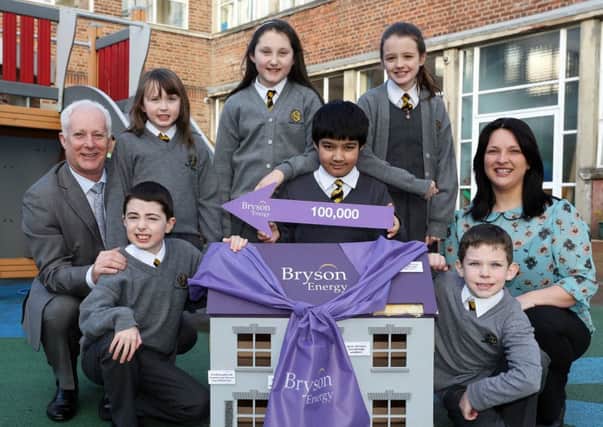 Elaine Brownlee, Education Advisor, Bryson Energy, right, pictured with Principal Paul Sheridan from Model Primary School left and pupils, front row, from left, Oran Mullan and Adam Divin and back row, Corrina Lane, Caoirse McCann, Joshan Singh and Sarah Nelson.